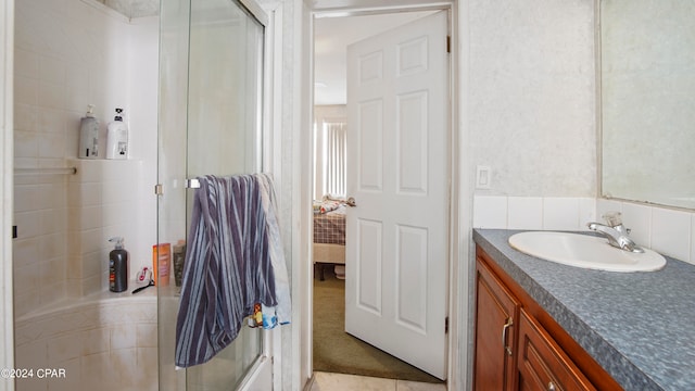 bathroom with walk in shower and vanity