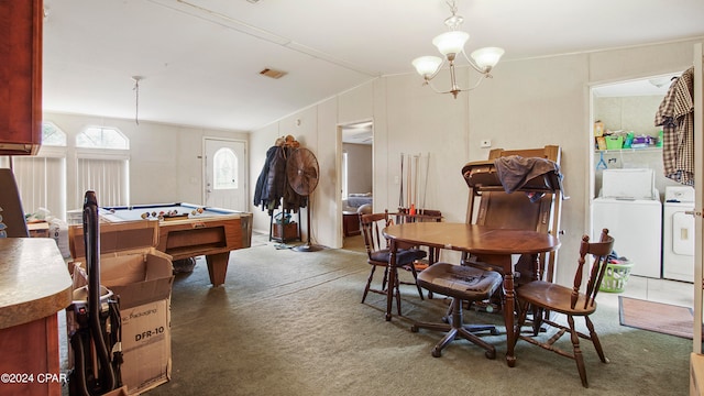 interior space with dark carpet, lofted ceiling, a notable chandelier, and independent washer and dryer