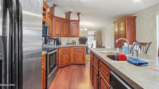 kitchen with lofted ceiling, sink, stainless steel appliances, a notable chandelier, and dark hardwood / wood-style flooring