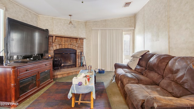 living room with lofted ceiling, a fireplace, and dark colored carpet