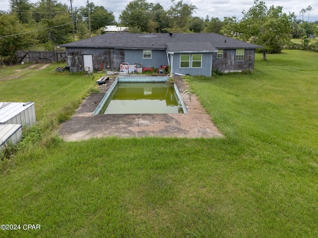 rear view of property with a yard