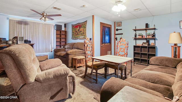 living room featuring ceiling fan, a paneled ceiling, and carpet