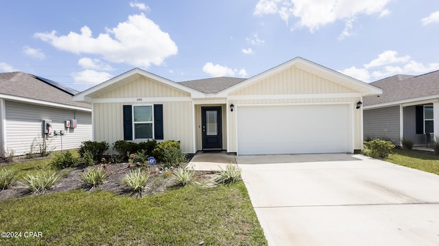 ranch-style home featuring a front yard and a garage