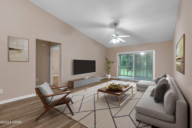 living room featuring ceiling fan, light wood-type flooring, and high vaulted ceiling