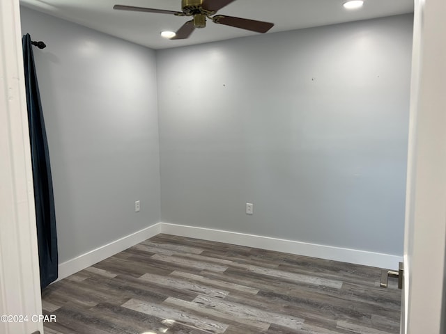 spare room featuring ceiling fan and dark wood-type flooring