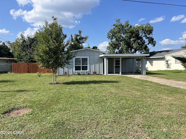 ranch-style home with a front lawn and a carport