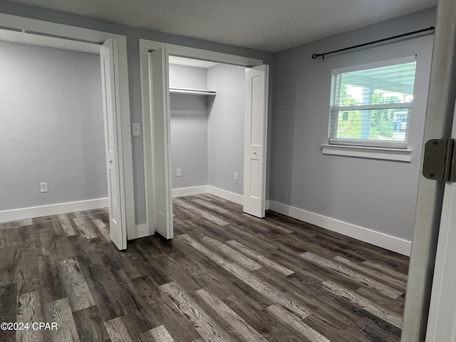 unfurnished bedroom featuring a closet and dark hardwood / wood-style floors