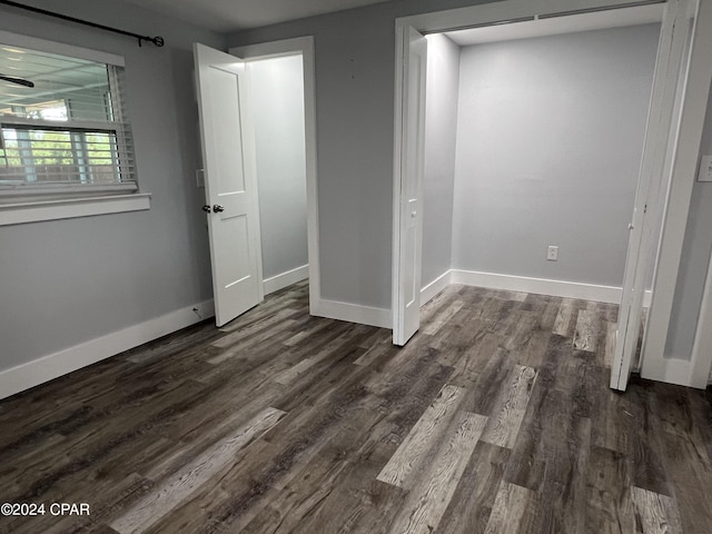 unfurnished room featuring dark wood-type flooring