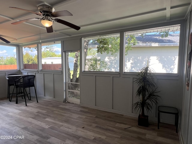 sunroom featuring ceiling fan