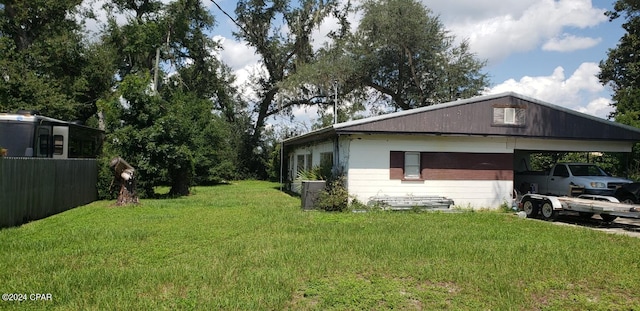 view of property exterior featuring a lawn and a carport