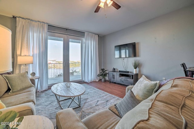 living room featuring ceiling fan, french doors, and light hardwood / wood-style flooring