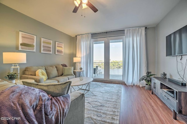 living room with light wood-type flooring and ceiling fan