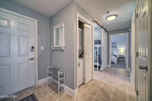 tiled foyer with a barn door