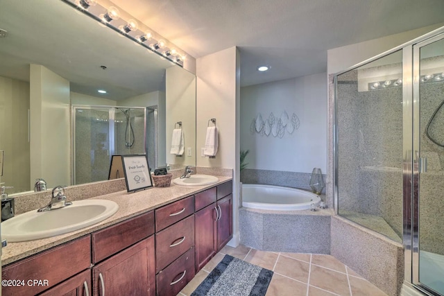 bathroom with tile patterned floors, independent shower and bath, and vanity