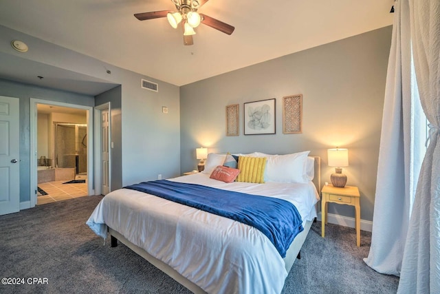 carpeted bedroom with ensuite bath and ceiling fan