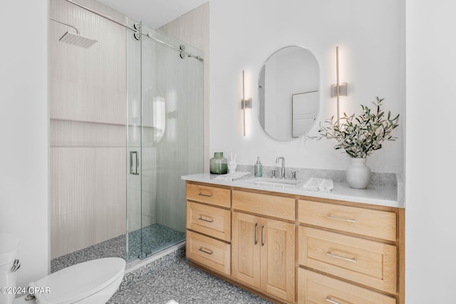 bathroom with walk in shower, vanity, and toilet