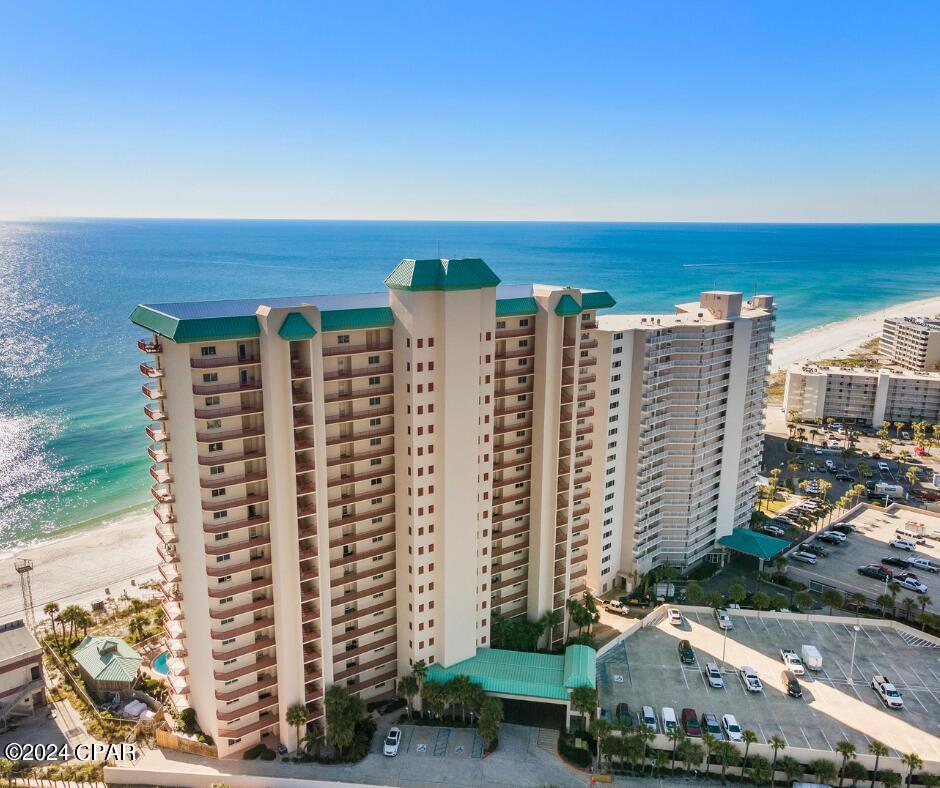 bird's eye view featuring a water view and a beach view