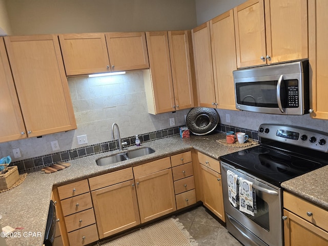 kitchen with appliances with stainless steel finishes, tasteful backsplash, sink, tile patterned flooring, and light brown cabinets