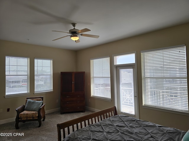 carpeted bedroom with multiple windows and ceiling fan