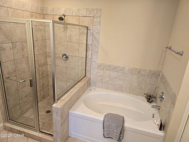 bathroom featuring plus walk in shower and tile patterned flooring