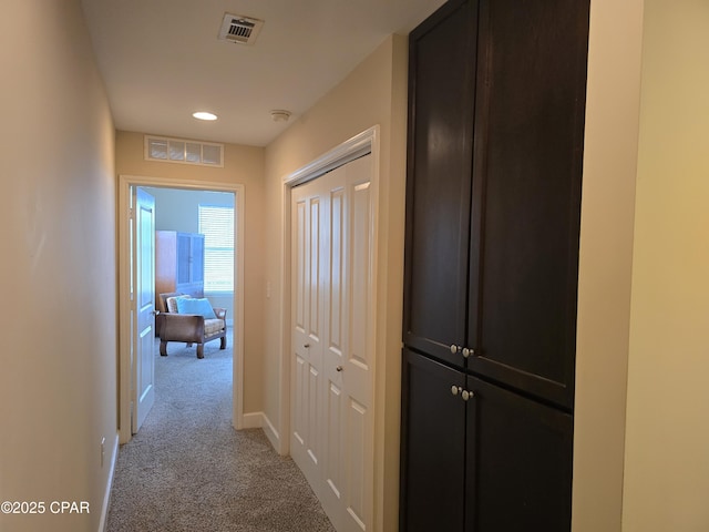 hallway with light colored carpet