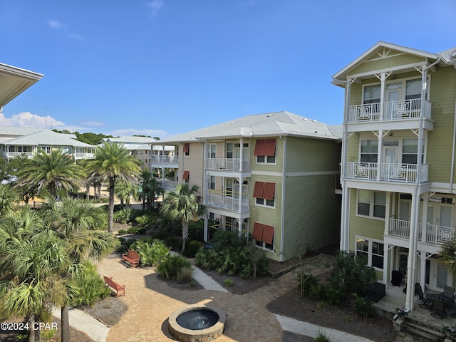 view of building exterior with an outdoor fire pit