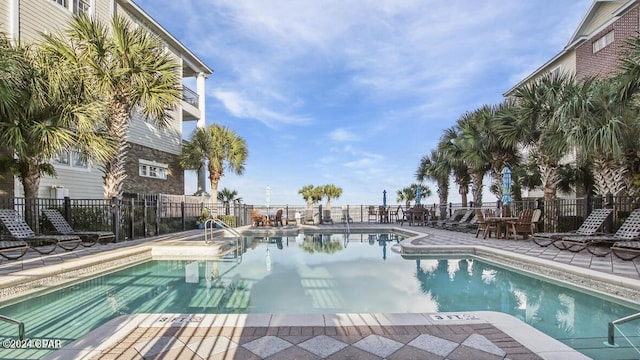 pool with fence and a patio