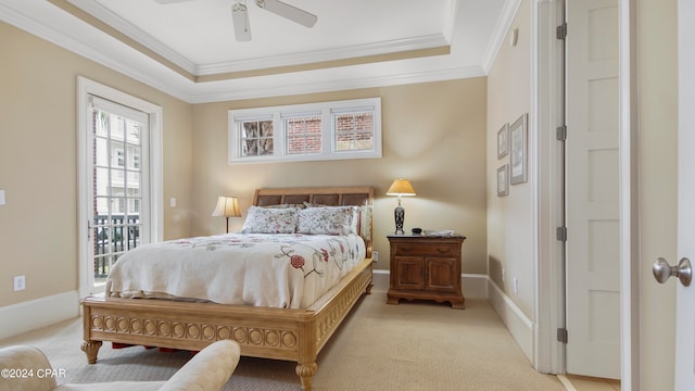 bedroom featuring light carpet, ceiling fan, a raised ceiling, and crown molding