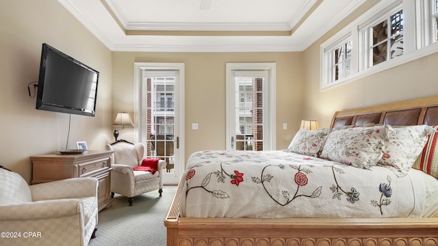 carpeted bedroom featuring access to outside, a raised ceiling, and ornamental molding