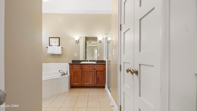 bathroom with ornamental molding, tile patterned flooring, vanity, and shower with separate bathtub