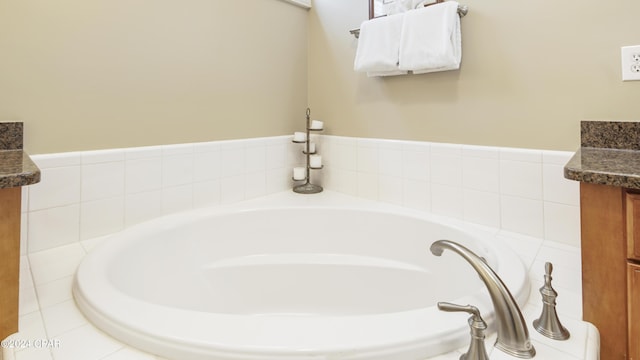 full bathroom featuring vanity and a bath