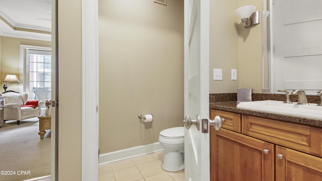bathroom with baseboards, ornamental molding, toilet, vanity, and tile patterned flooring