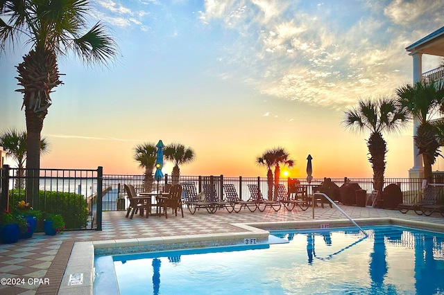 view of pool at dusk