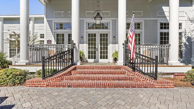 entrance to property with covered porch and french doors