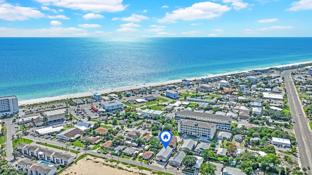 bird's eye view featuring a water view and a beach view