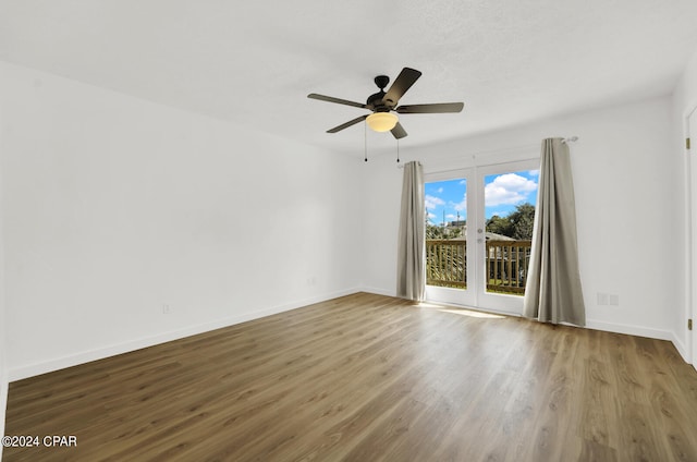 empty room with ceiling fan and wood-type flooring