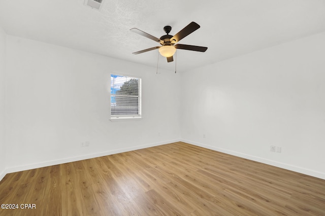 spare room with ceiling fan, hardwood / wood-style floors, and a textured ceiling