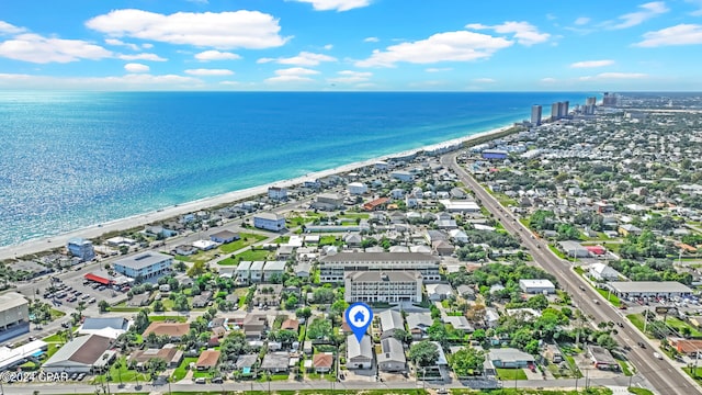 drone / aerial view featuring a beach view and a water view