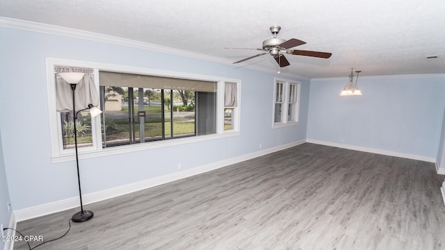 empty room featuring ceiling fan, hardwood / wood-style flooring, crown molding, and a textured ceiling