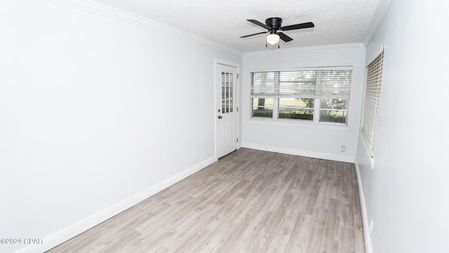 spare room featuring a textured ceiling, crown molding, light hardwood / wood-style floors, and ceiling fan