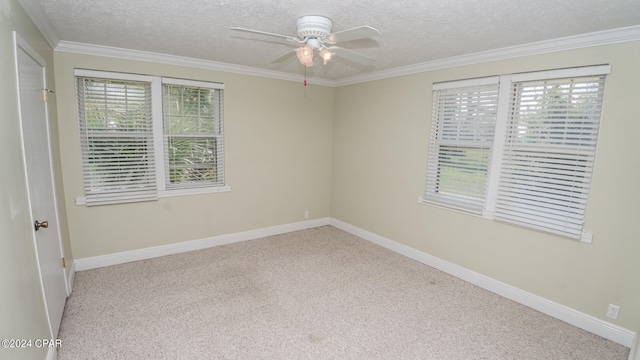 spare room with ornamental molding, carpet, ceiling fan, and a textured ceiling