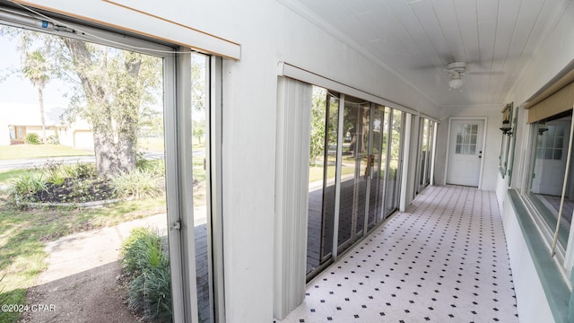 sunroom / solarium featuring a wealth of natural light and ceiling fan