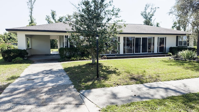 single story home with a front lawn and a carport