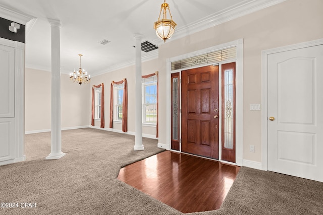 entryway featuring carpet flooring, decorative columns, and ornamental molding