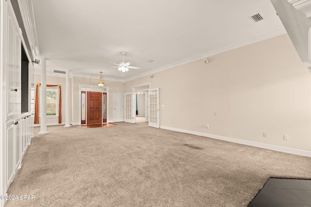 unfurnished living room with ceiling fan, carpet flooring, french doors, crown molding, and ornate columns