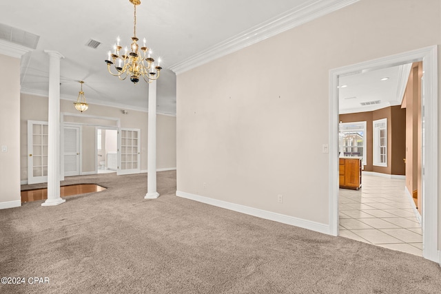 interior space featuring decorative columns, ornamental molding, french doors, and a notable chandelier