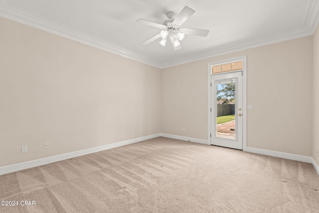 carpeted empty room featuring ceiling fan and crown molding