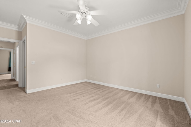 carpeted empty room with crown molding and ceiling fan