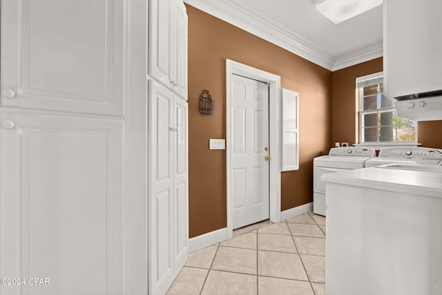 laundry room with cabinets, crown molding, light tile patterned floors, and independent washer and dryer