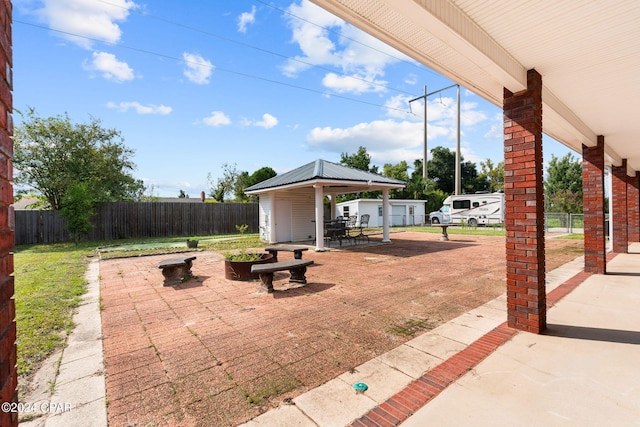 view of patio / terrace featuring a garage and an outdoor fire pit